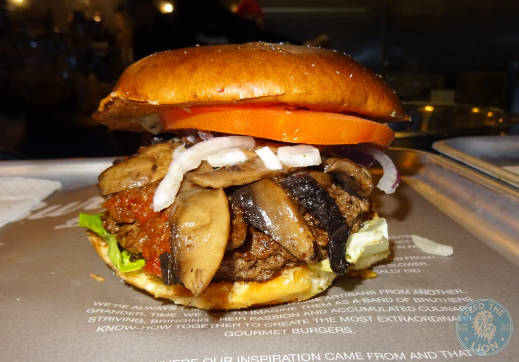 Burgista Bros PORTABELLO BURGER - lettuce, heritage tomato, red onion and their own burger sauce, topped with roasted sliced Portabello mushroom, tomato and black olive chutney and shaved black summer truffle.